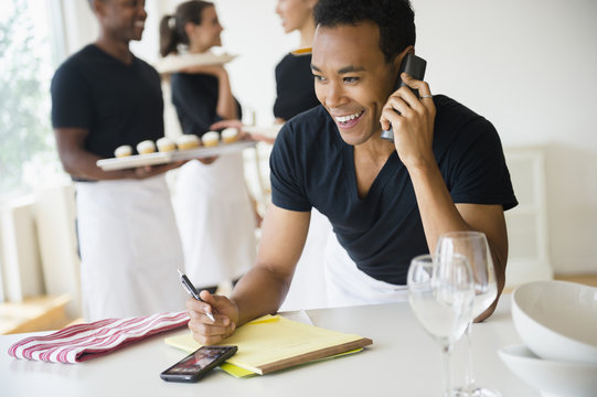 Caterer talking on phone in event space