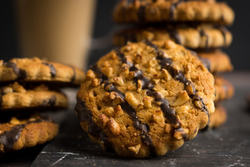 Glass of coffee with cookies on wooden background