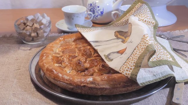 removal of a napkin from festive pie on a half 4k
