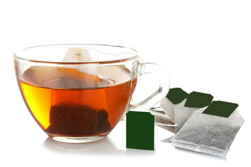 a bag of brewed green tea in transparent Cup on white isolated background