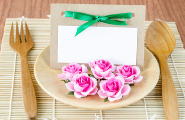 Romantic dinner table setting with blank note.