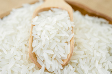 Jasmine rice with wooden spoon.