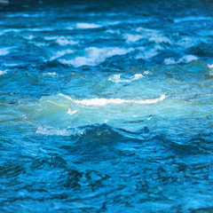 Sea wave on dark blue water