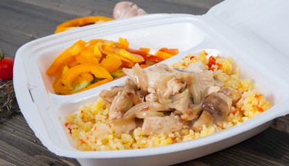 Rice with meat, vegetables, mushrooms and salad in lunch box
