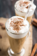 Coffee in glass on the wooden background