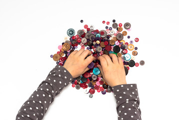 Child hands in colorful buttons