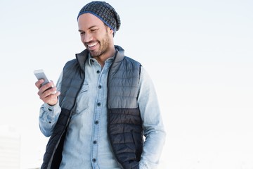 Young man text messaging on mobile phone