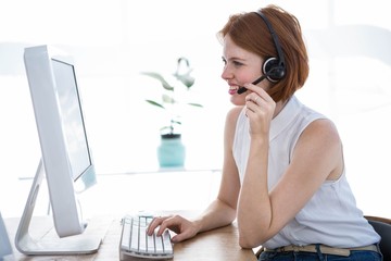 smiling hipster business woman wearing a headset