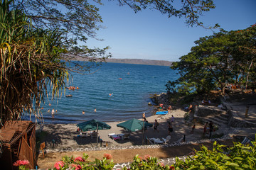 Masaya, Nicaragua – March 12, 2016: Apoyo Lagoon view with people on recreation in sunny day on summer.