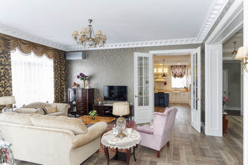 The living room with a sofa and comfortable chairs with a tv.