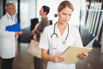 Female doctor reading a medical report