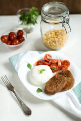 Plate of Caprese Salad with Mozzarella Cheese, Tomatoes, Basil a