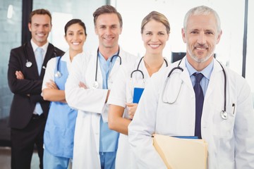 Fototapeta premium Happy medical team standing with arms crossed