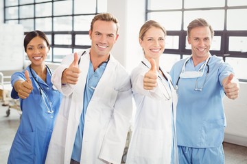 Medical team putting their thumbs up and smiling