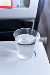 Glass of water in an airplane. 