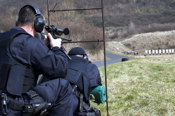 Fototapeta premium Military sniper aims at a target