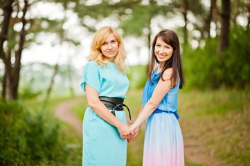 Fototapeta premium Happy family. Young mother and daughter at pine forest