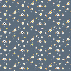 Spring small wild flower field seamless pattern. Floral blue and mustard fine summer vector pattern on dark blue background. For fabric textile prints and apparel.