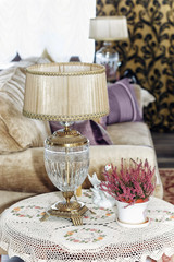 Little table with a lamp and a flower