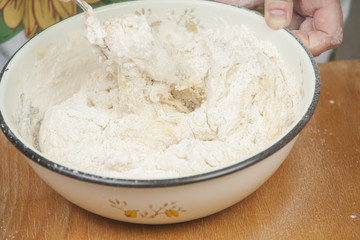 Women's hands preparing fresh yeast dough