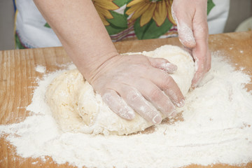 Women's hands preparing fresh yeast dough