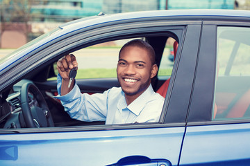 happy, smiling, young man, buyer sitting in his new blue car showing keys