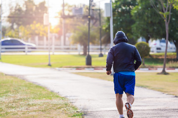 Fit man running and jogging in the park. © jayzynism