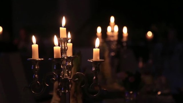 Candles  in vintage candlestick in a dark interior