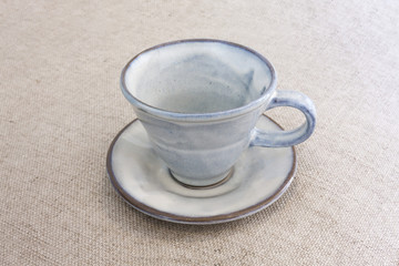 indigo blue empty coffee cup on brownish background
