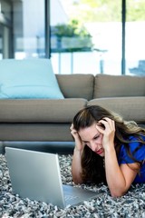 stressed woman looking at her laptop