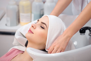 Beautiful woman sitting in the hairdressing salon  