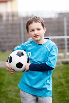 7 years boy - footballer with football ball.