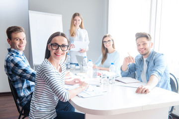 Cheerful team standing on the table 