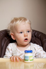 Two year baby boy sitting at the dinner table