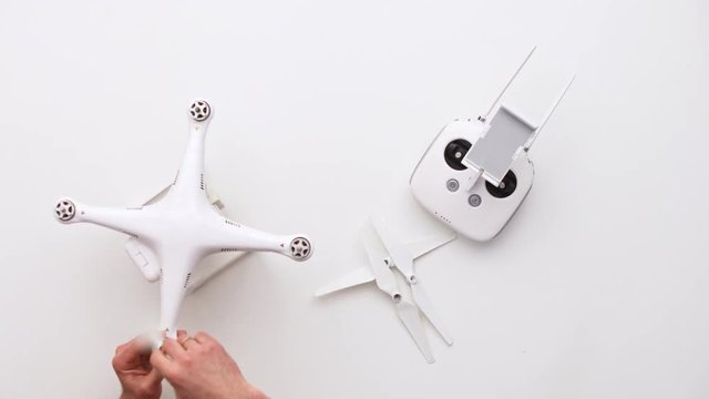 Man installing dron at his office desk. Upview