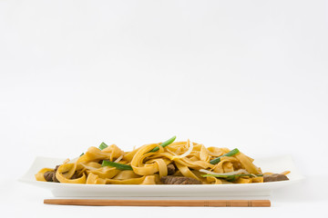 Chinese food. Beef chow mein. White background
