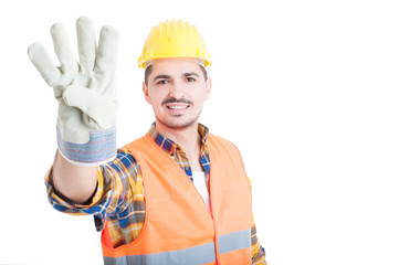 Joyful young constructor or builder with number four gesture