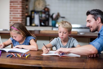 Father helping kids with their homework