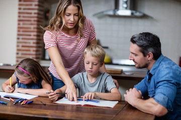 Parents helping the kids with their homework