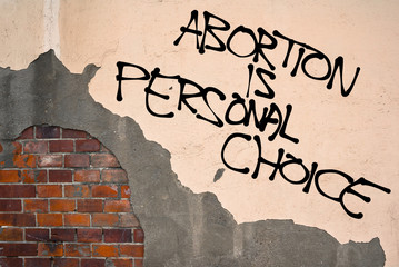 Handwritten graffiti Abortion Is Personal Choice sprayed on the wall, anarchist aesthetics 