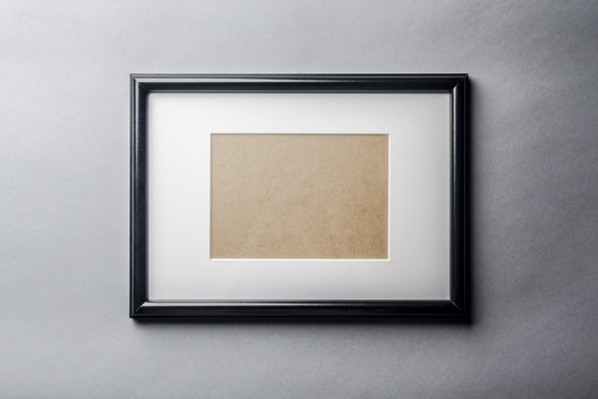 Black Plain Empty Thin Wood Picture Frame With White Mat Passe-partout On Grey Wall Background