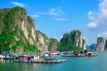 Floating village near rock islands in Halong Bay