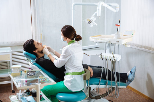 Doctor making procedures in dental office with the patient