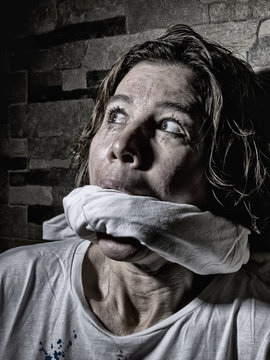 Close-up of a woman gagged and abused 