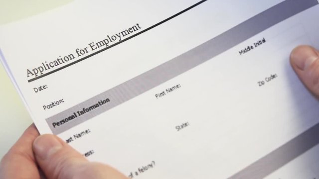 Job Applicant With Employment Form in Hands. An application for employment or job application is a form or collection of forms that an individual seeking employment, called an applicant, must fill out