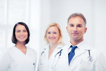 doctor with stethoscope and colleagues