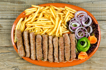 Kebabs with onions and french fries