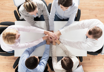close up of business team with hands on top