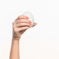 Fototapeta na wymiar The female hand holding white blank styrofoam oval 
