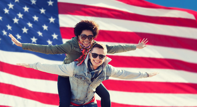 happy multiracial couple over american flag